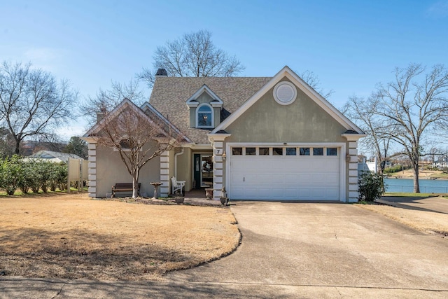 view of front property featuring a garage and a water view