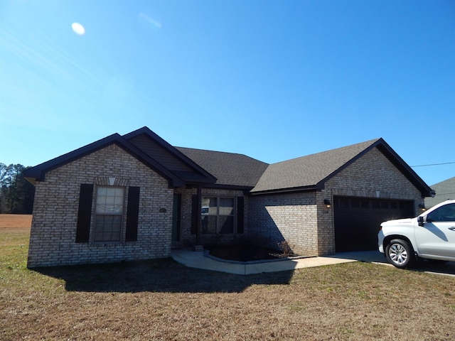 view of front of home with a garage and a front yard