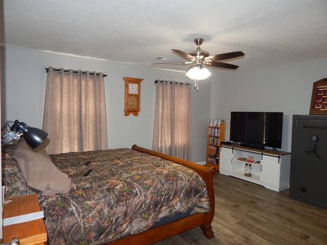 bedroom with dark wood-type flooring and ceiling fan