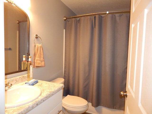 bathroom featuring vanity, toilet, and curtained shower