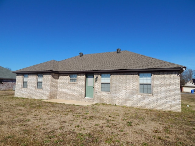 rear view of house with a patio area and a lawn