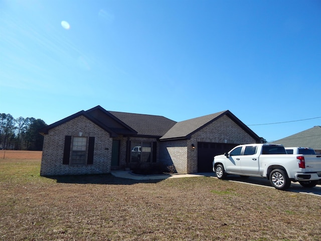 view of front of property with a garage and a front lawn