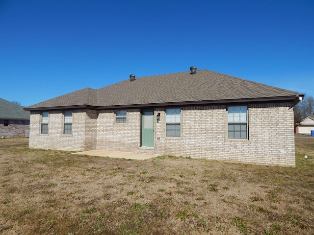 back of property featuring a patio and a yard