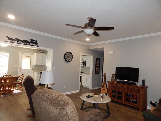 living room featuring crown molding, dark hardwood / wood-style floors, and ceiling fan