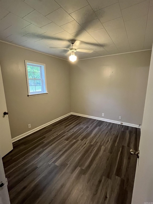 spare room with crown molding, ceiling fan, and dark hardwood / wood-style flooring