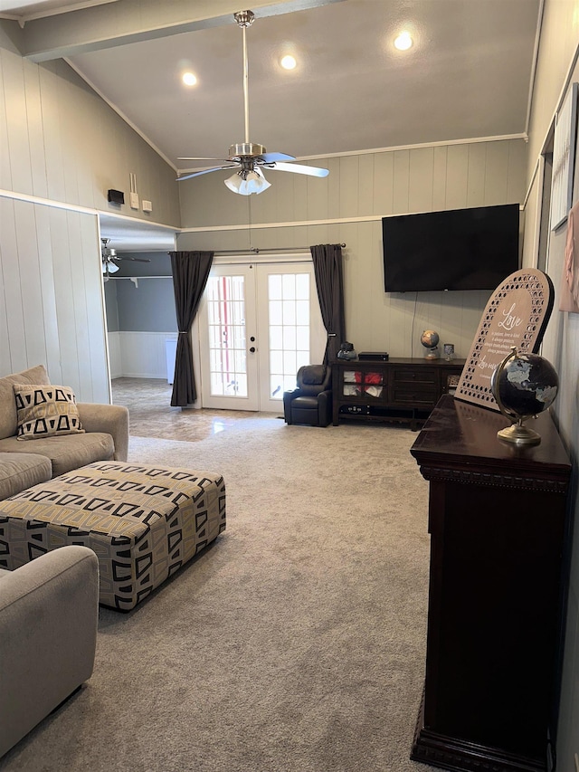 carpeted living room with french doors, ceiling fan, and lofted ceiling with beams