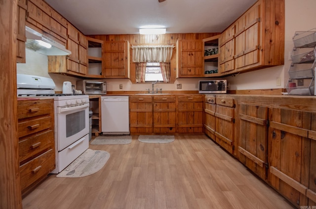 kitchen with sink, white appliances, and light hardwood / wood-style flooring