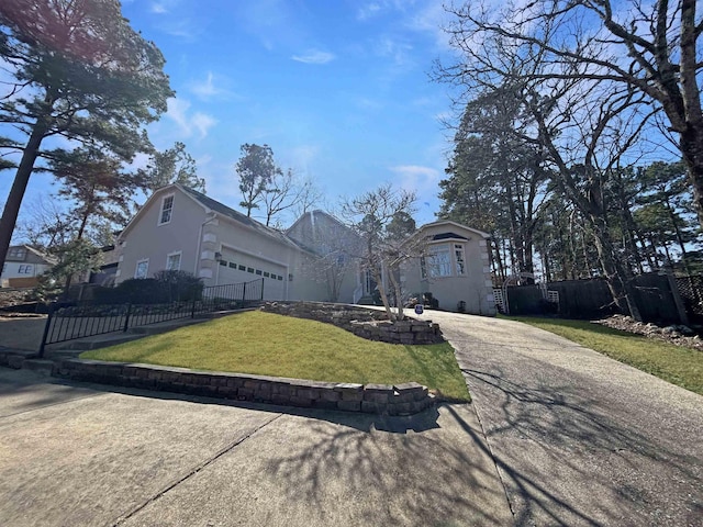 view of front of home with a garage and a front lawn