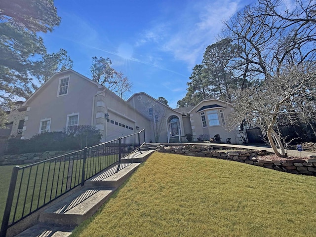 view of front of house with a garage and a front yard