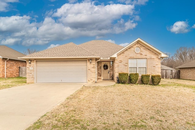 ranch-style home featuring a garage and a front lawn