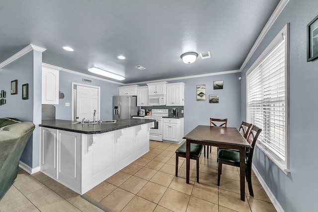 kitchen featuring sink, white cabinetry, ornamental molding, kitchen peninsula, and white appliances