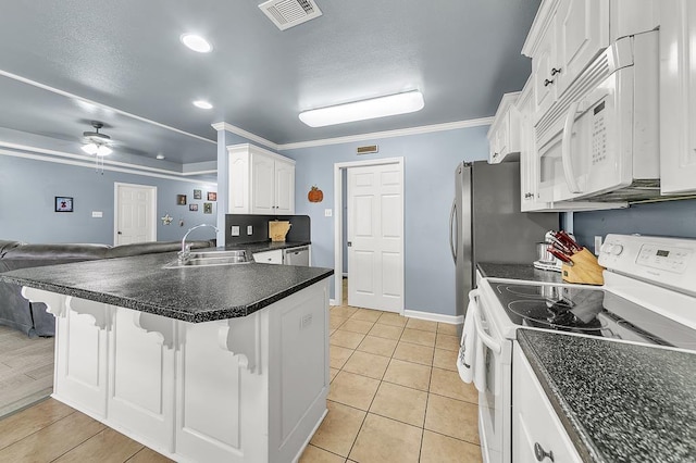 kitchen featuring a breakfast bar, sink, white cabinets, ceiling fan, and white appliances