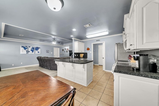 kitchen featuring light tile patterned flooring, sink, white cabinets, ceiling fan, and crown molding