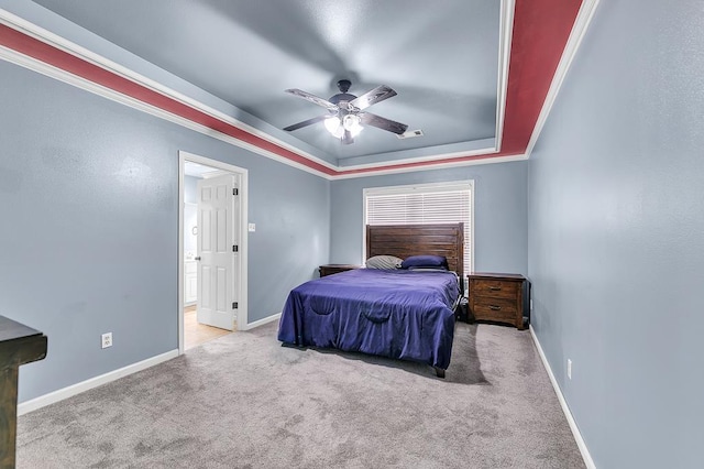 bedroom with a raised ceiling, ornamental molding, light carpet, and ceiling fan