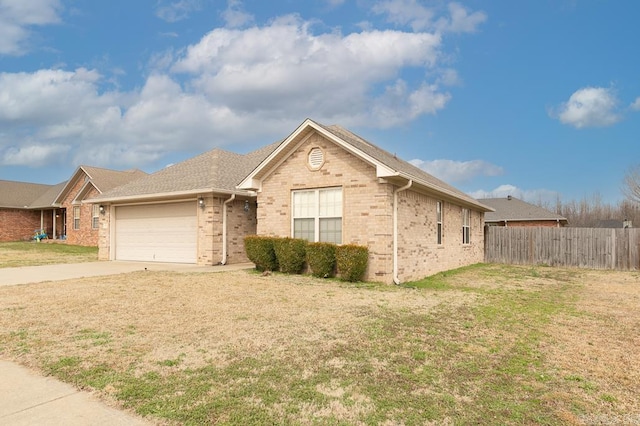 single story home featuring a garage and a front lawn