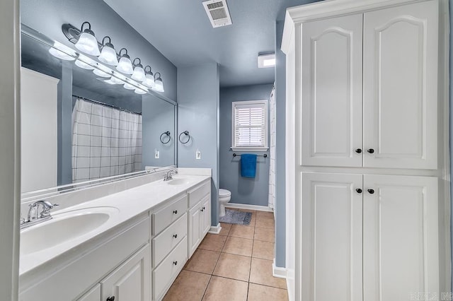 bathroom featuring tile patterned flooring, vanity, a shower with curtain, and toilet