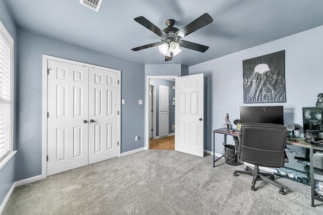 carpeted office with ceiling fan