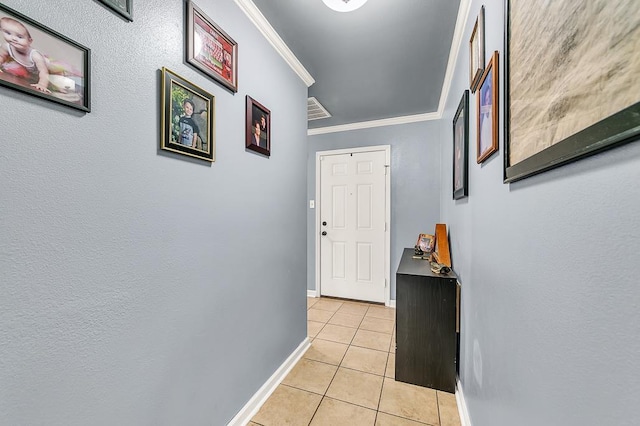 hallway featuring crown molding and light tile patterned floors