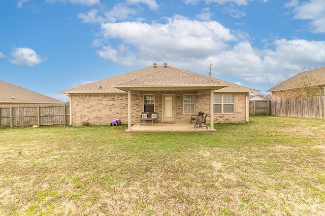 back of property with a patio and a lawn