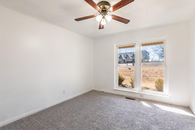 spare room with carpet floors, a textured ceiling, and ceiling fan