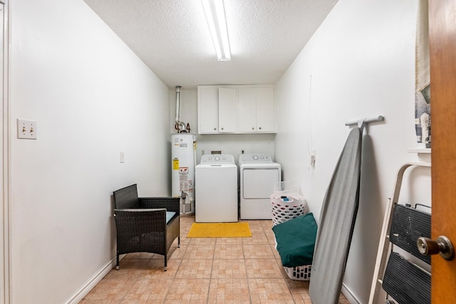 washroom with cabinets, gas water heater, washer and dryer, and a textured ceiling