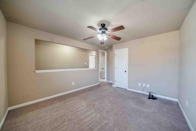 carpeted empty room with ceiling fan