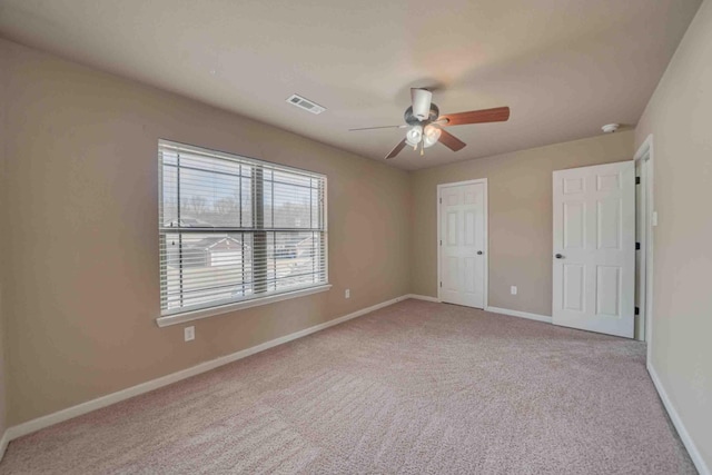 unfurnished bedroom featuring light carpet and ceiling fan