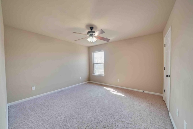 empty room featuring ceiling fan and light carpet