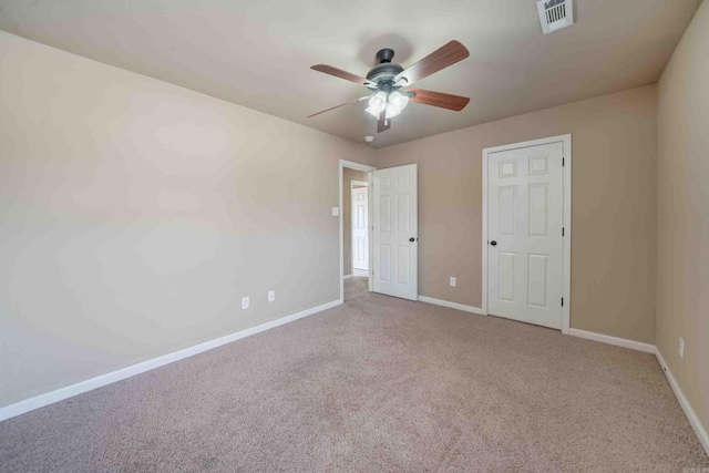 unfurnished bedroom with light colored carpet and ceiling fan