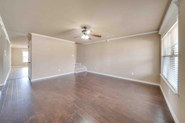 empty room featuring ceiling fan, ornamental molding, and dark hardwood / wood-style floors