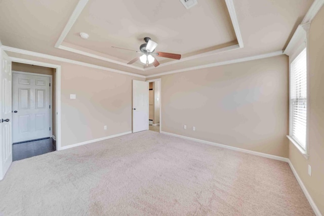 carpeted spare room featuring ceiling fan, ornamental molding, and a tray ceiling