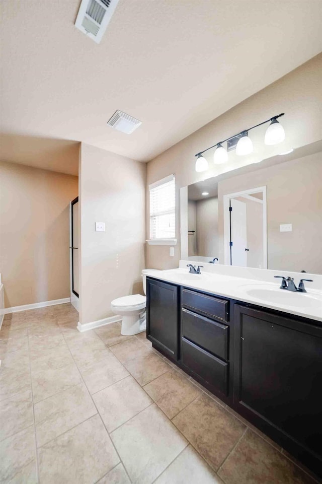 bathroom featuring vanity, toilet, and tile patterned flooring