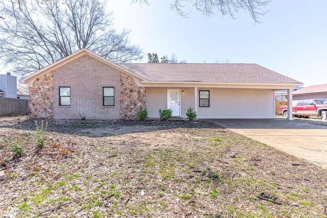 single story home featuring roof with shingles, fence, and brick siding