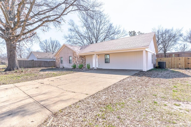 ranch-style home featuring fence and central air condition unit