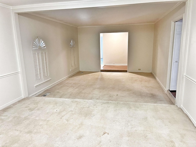 empty room featuring light carpet and ornamental molding