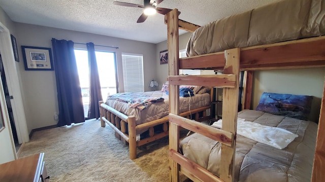 bedroom featuring ceiling fan, light colored carpet, and a textured ceiling