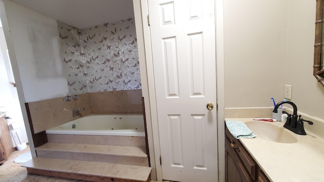 bathroom featuring vanity and a relaxing tiled tub