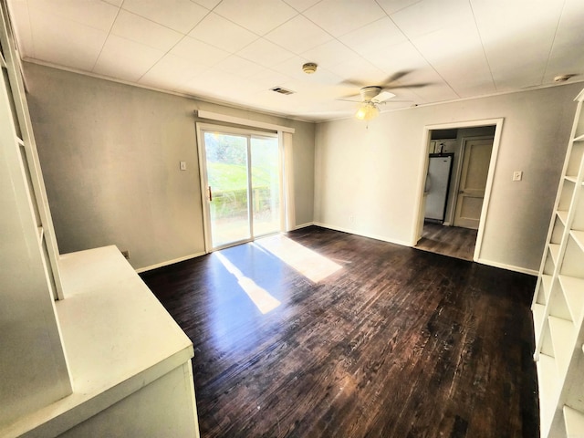 empty room featuring ceiling fan and dark hardwood / wood-style flooring