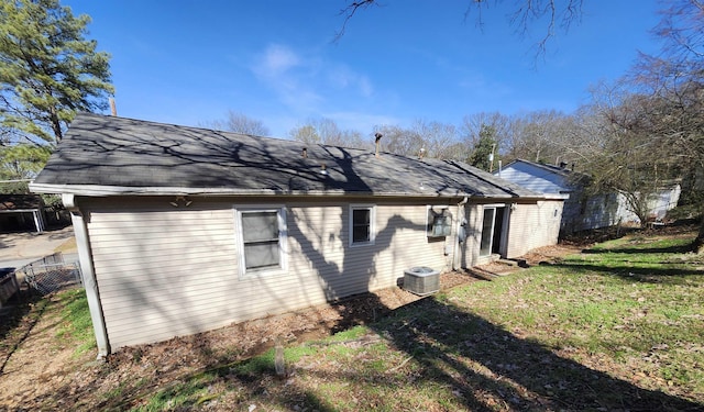 view of side of home featuring a yard and central air condition unit