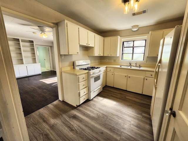 kitchen with white appliances, ceiling fan, sink, and dark hardwood / wood-style flooring