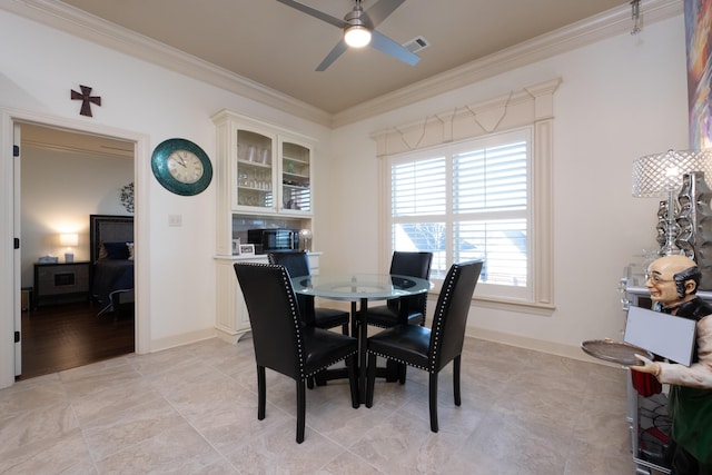 dining room with ceiling fan and ornamental molding