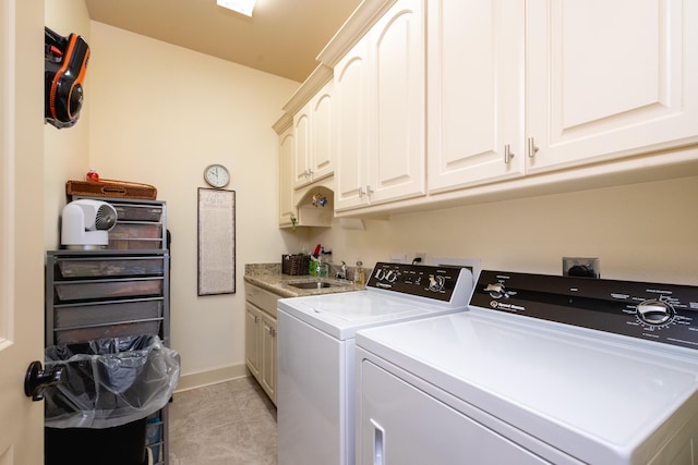 laundry room featuring cabinets, washer and dryer, and sink