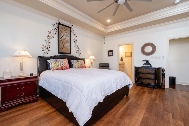 bedroom featuring ensuite bath, dark wood-type flooring, and ornamental molding