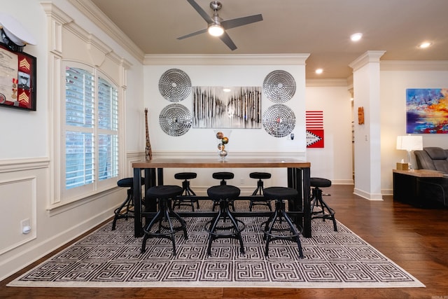 dining room with ceiling fan, dark hardwood / wood-style flooring, and ornamental molding