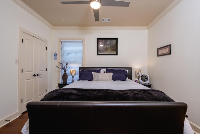 bedroom featuring ceiling fan, a closet, dark wood-type flooring, and ornamental molding