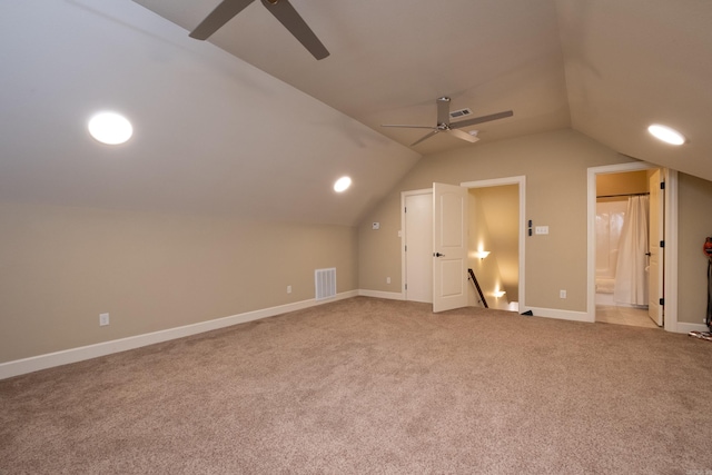 bonus room with lofted ceiling, ceiling fan, and light colored carpet