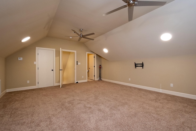 additional living space with carpet floors, vaulted ceiling, and ceiling fan