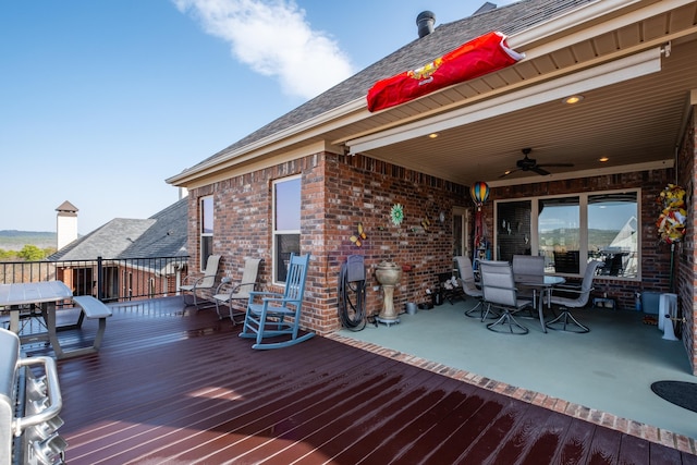 wooden deck featuring ceiling fan