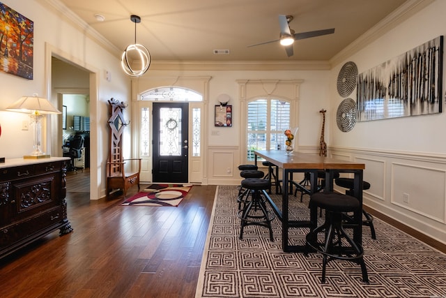 foyer with crown molding and dark hardwood / wood-style floors