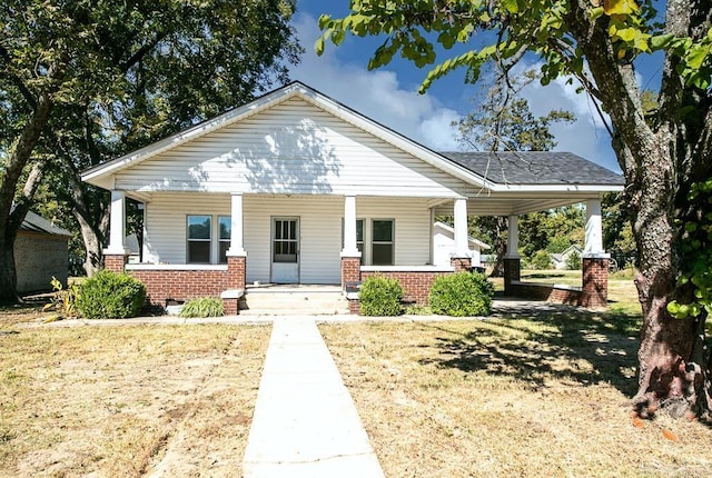 bungalow-style home with a porch and a front yard